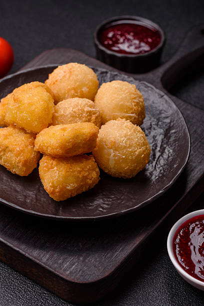 istock Fried mozzarella or brie cheese with cranberry or raspberry sauce 2211723584