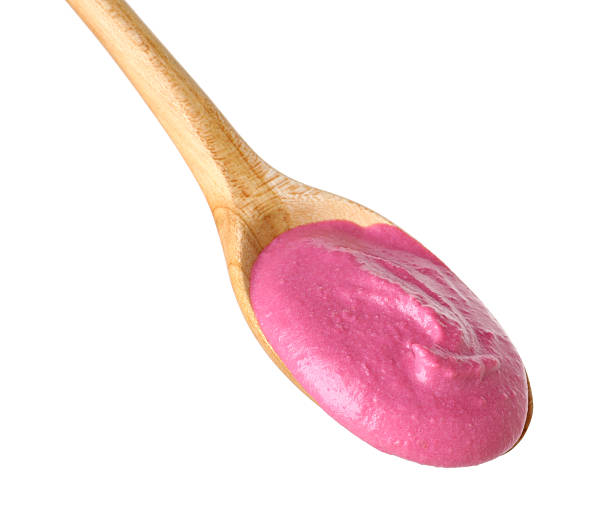istock Tasty beetroot hummus in wooden spoon isolated on white 2211723820
