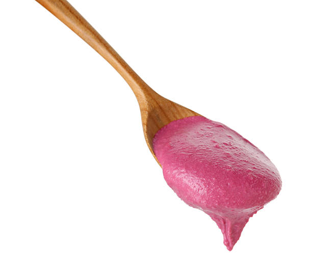 istock Tasty beetroot hummus in wooden spoon isolated on white 2211723890