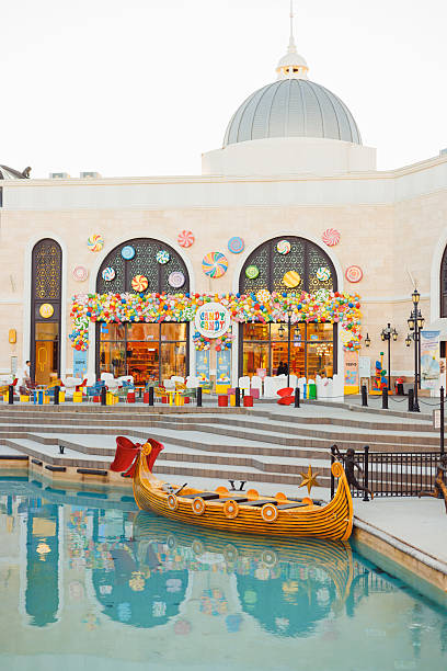 The Land of Legends shopping street, aquapark and theme park Turkiye, Antalya - 12.03.2025:The Land of Legends shopping street, aquapark and theme park is a popular tourist destination near Belek, Antalya. Fairy-tale boat gondola for tourists on water belek town stock pictures, royalty-free photos & images