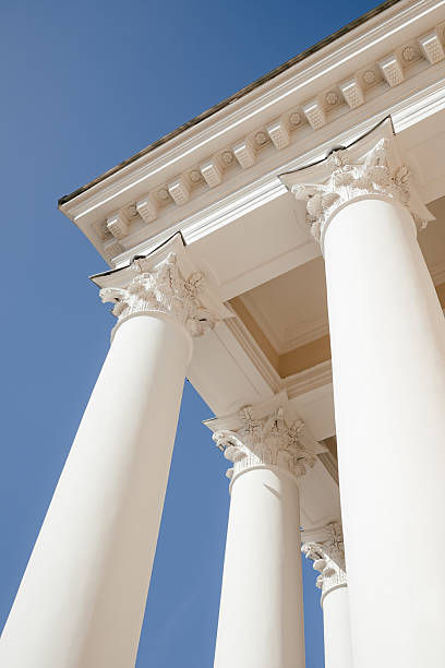 istock Majestic White Architectural Columns Against Blue Sky 2211724062