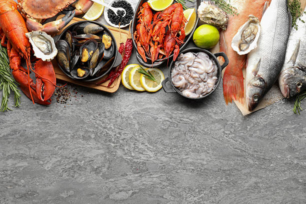 istock Many different sea food on grey table, top view 2211724085