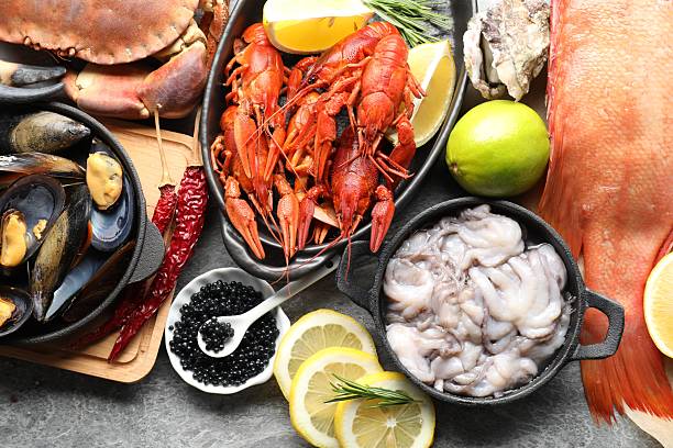 istock Many different sea food on grey table, top view 2211724243