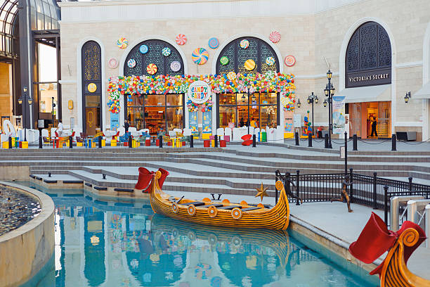 The Land of Legends shopping street, aquapark and theme park Turkiye, Antalya - 12.03.2025:The Land of Legends shopping street, aquapark and theme park is a popular tourist destination near Belek, Antalya. Fairy-tale boat gondola for tourists on water belek town stock pictures, royalty-free photos & images