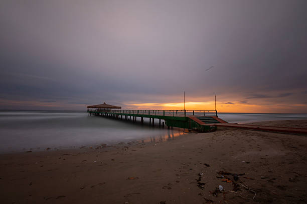 istock Old pier on the beach taken with long exposure technique 2211725481