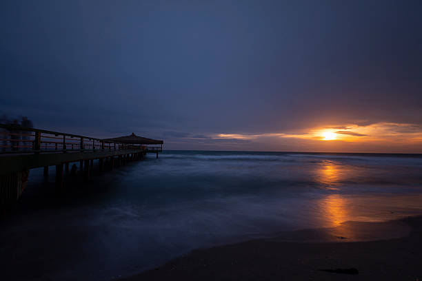 istock Old pier on the beach taken with long exposure technique 2211725488
