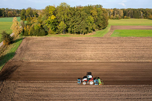istock Tractor sowing grain in a field 2211725758