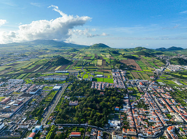 Green landscape and city in Ponta Delgada Rural landscape with farmlands and residential areas in Ponta Delgada, viewed from above san diego freeway stock pictures, royalty-free photos & images