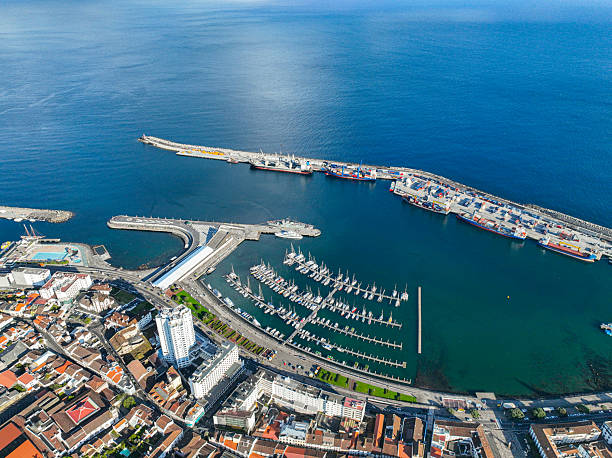 Aerial photo of boats and piers in Ponta Delgada harbor with urban backdrop
