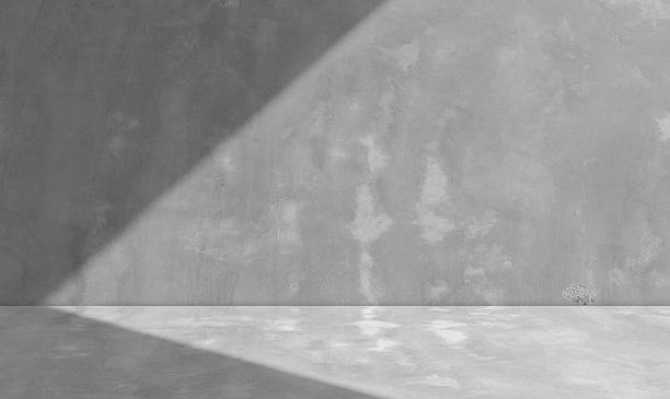 istock Empty grey concrete loft wall room interior studio background and floor with shadow light perspective well editing display products and text on free space raw cement backdrop 2211730260