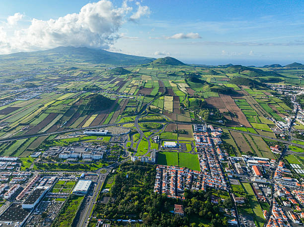 Green landscape and city in Ponta Delgada Rural landscape with farmlands and residential areas in Ponta Delgada, viewed from above san diego freeway stock pictures, royalty-free photos & images
