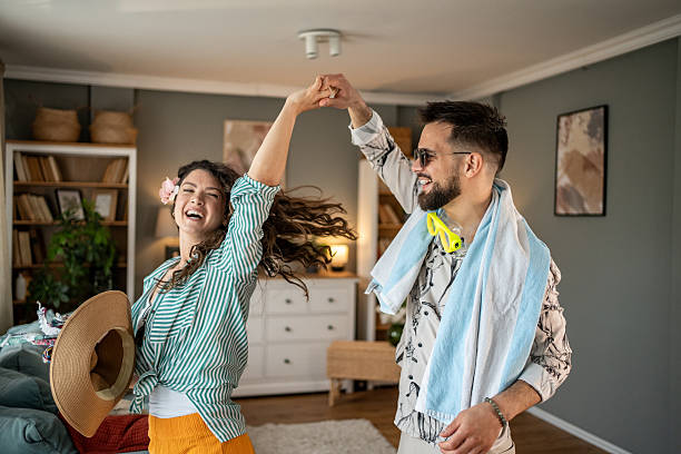 istock Happy couple dancing together at home after returning from vacation 2211734029