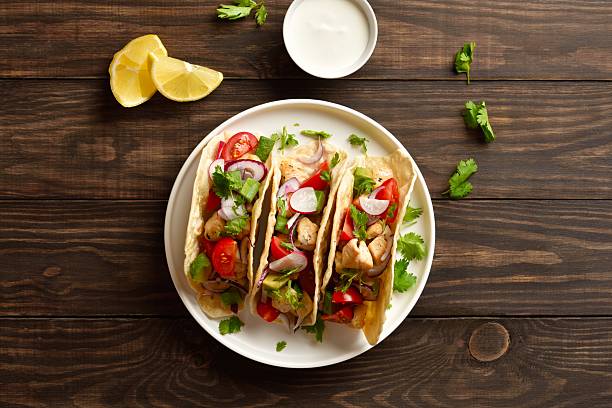 istock Tacos with vegetables and meat on wooden background 2211738049