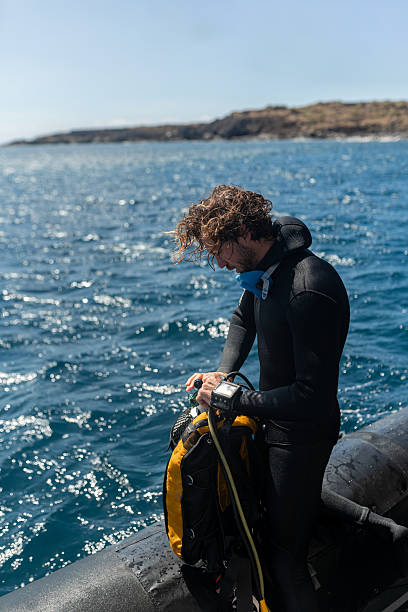 istock Scuba diver setting up gear on inflatable boat before ocean dive 2211738600
