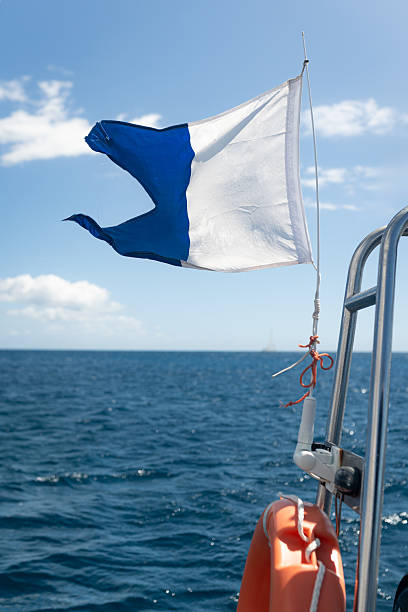 istock Diver down flag waving on a boat in the sea 2211738607