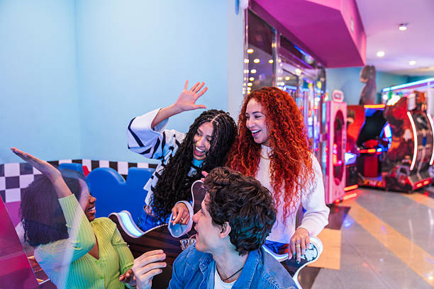 istock Friends playing arcade games and having fun together 2211740558