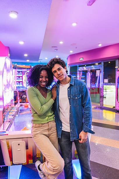 istock Young couple having fun playing arcade games in bowling alley 2211743268