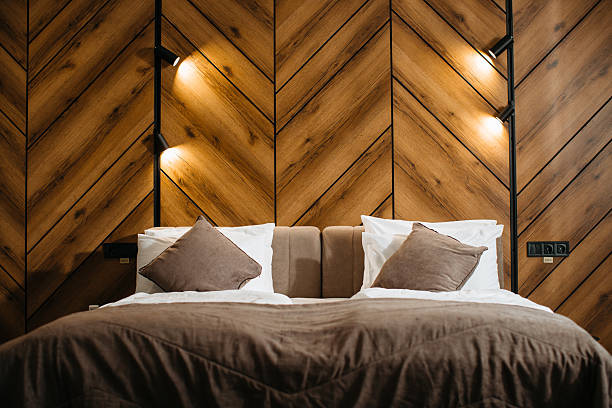 istock Comfortable hotel room with wooden wall and modern lighting 2211743539