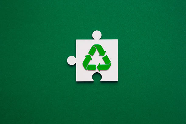 istock Recycling Symbol Puzzle Piece on Green Background 2211744036