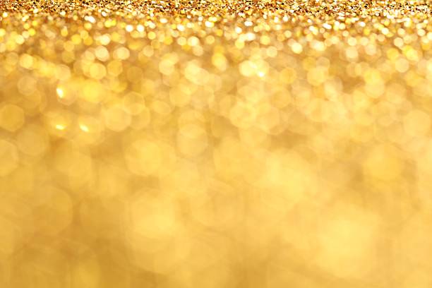 Beautiful shiny golden glitter as background, closeup