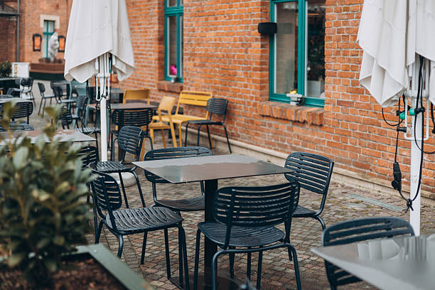 istock Outdoor cafe seating with tables and chairs 2211745921