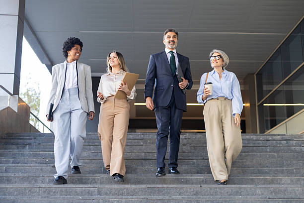 istock Business people walking down steps outside office building 2211746392