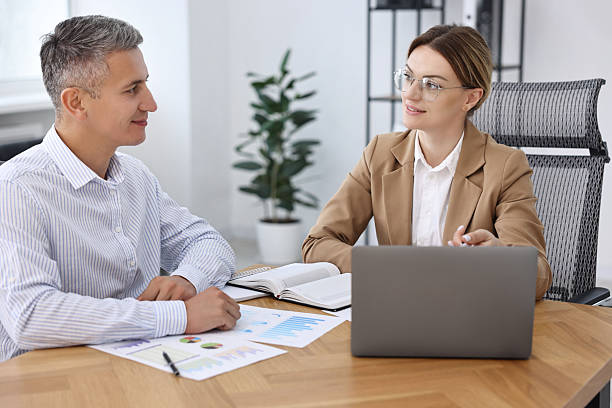 istock Banker working with client at wooden table in office 2211746830