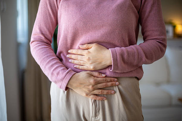Woman suffering from abdominal pain at home