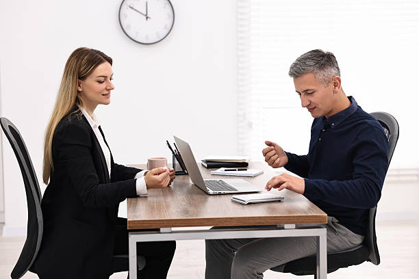 istock Banker working with client at table in office 2211747080