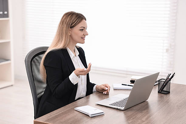 istock Banker with laptop working at table in office 2211747138