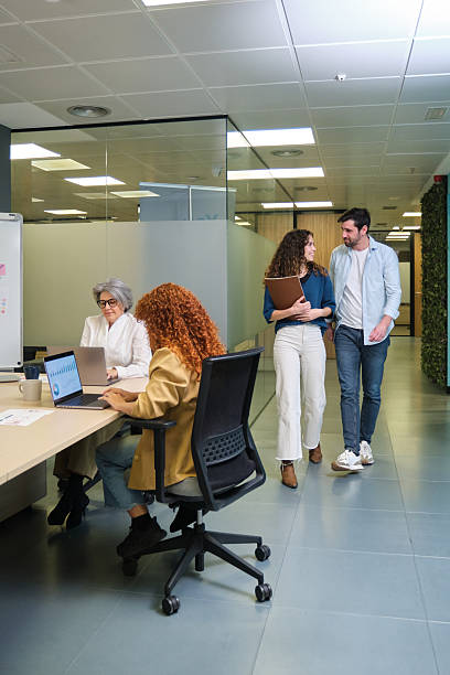 istock Business people walking and working in modern office 2211749473