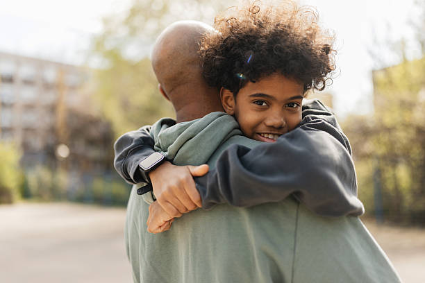 istock Child hugging adult from behind with affection 2211749571