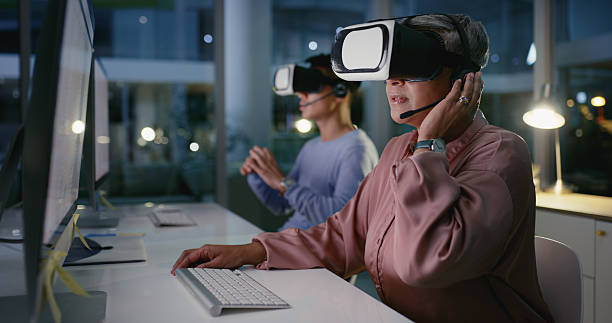 istock Virtual reality, call centre and futuristic for customer service, people and working late with computer. Business, representative and colleagues with digital goggles for 3D experience, tech and night 2211750565