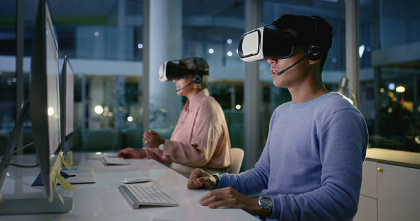 istock Vr headset, futuristic and people with tech, coworkers and working late with computer and happiness. Night, colleagues and customer service with digital software, smile and communication with mic 2211750574