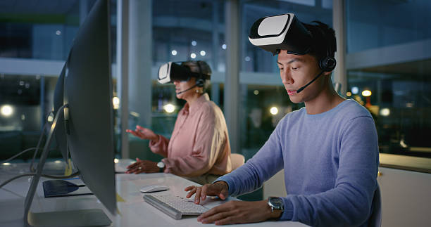 Vr headset, computer and people with tech, colleagues and man with microphone at night and call centre. Coworkers, communication and futuristic software for customer service, digital and working late