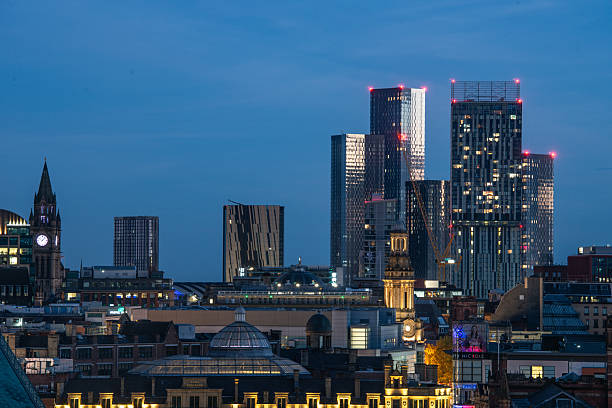 An image of Manchester City Centre skyline at dusk. Showing high-rise buildings, chuches