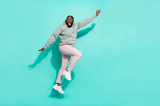 istock Full length body size view of attractive cheerful active guy jumping striving isolated over bright teal turquoise color background 2211753569