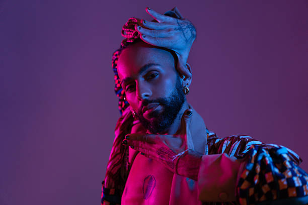 istock Neon light studio close-up portrait handsome black gay man looking camera. 2211762114