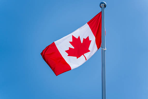 istock Canadian Flag and Blue Sky 2211766480