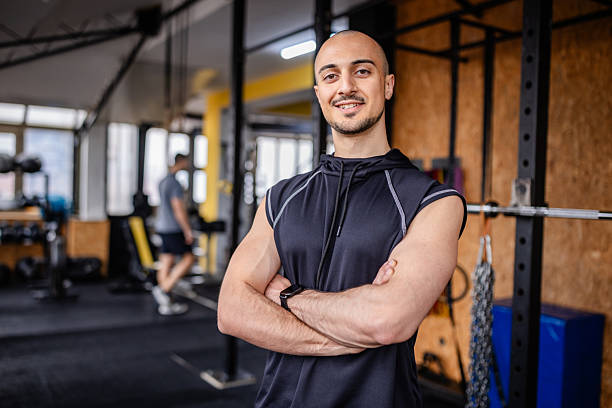 istock Young man demonstrates confidence and strength in a modern gym setting while engaging in fitness training 2211767181