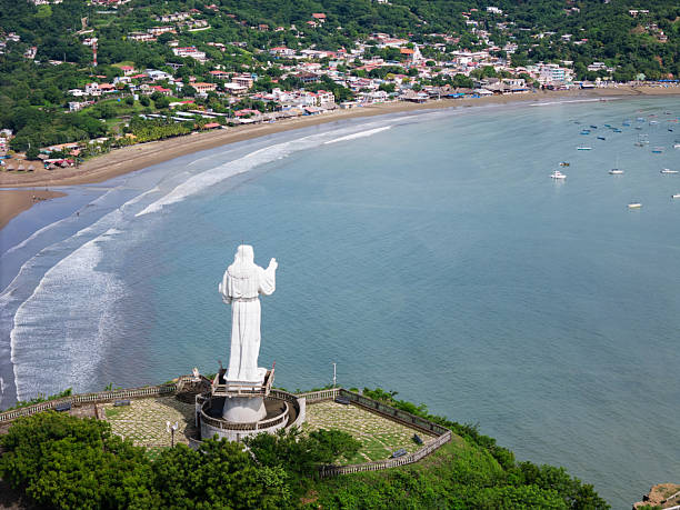 istock jesus christ staue monument on green hill 2211769155