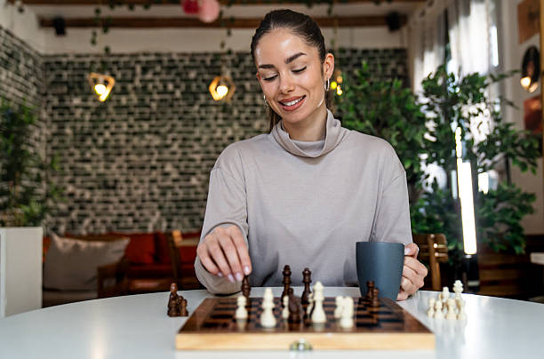 istock Young smiling woman playing chess 2211770781
