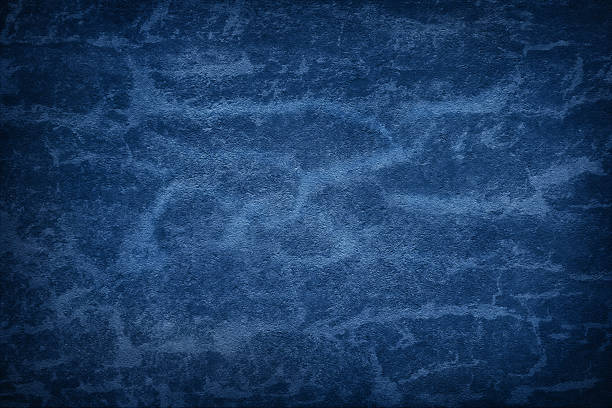 Texture of blue polished concrete background. Dark plaster wallpaper with rough cement texture. Empty grunge wall concept or floor backdrop. Abstract surface mockup. Top view, close up, copy space