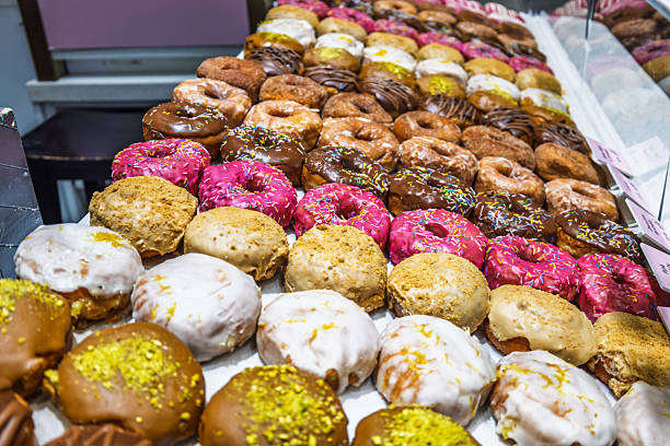 istock Colorful Assorted Donuts Displayed in Bakery Shop Showcase 2211772093