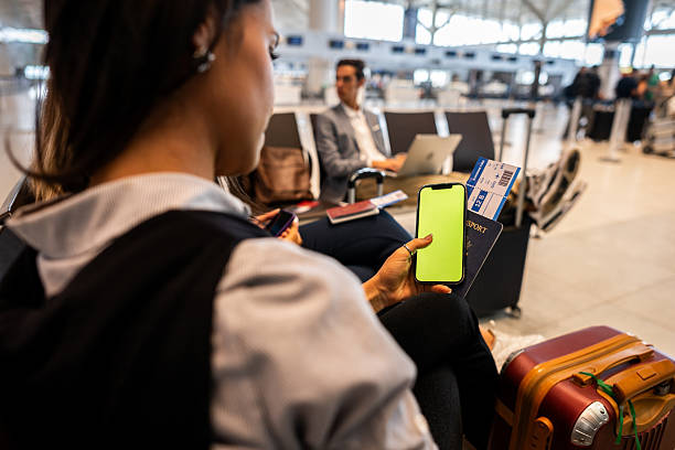 istock Woman using the mobile phone at the airport 2211773858