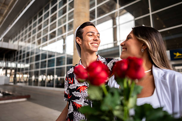 Young couple talking while walking at the airport