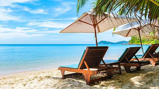 istock Paradise beach chairs under umbrellas on Koh Samet Island with turquoise waters and white sands 2211774425