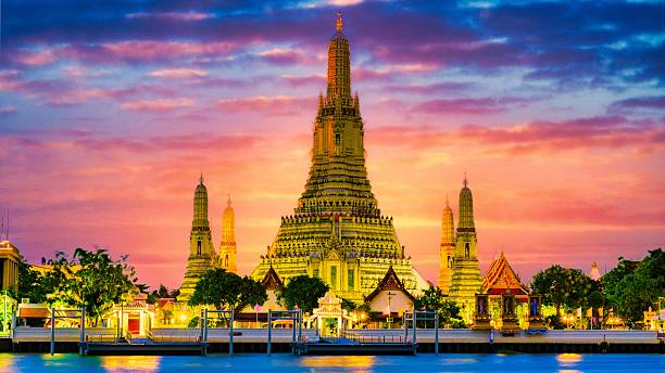 istock Dazzling Wat Arun temple illuminated at sunset alongside Chao Phraya River in Bangkok 2211774437