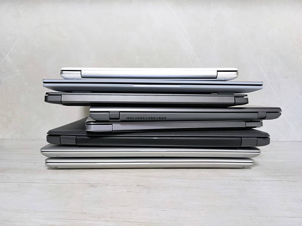 istock stack of laptops on a gray background, on the table, laptop computer, tablet, business, work, remote work, freelance. 2211775175