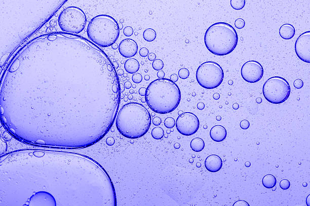 istock Texture, background, purple cosmetic bubbles macro,Liquid serum gel texture, oil drops on lavender color background. Clear skincare cosmetic product swatch with bubbles closeup 2211775441
